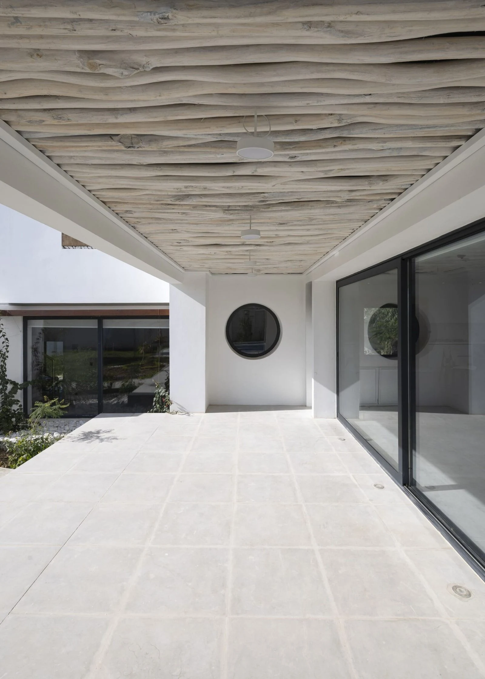 Terraza cubierta en relaci&oacute;n con los espacios interiores de Villa 144, de Lin3rd Architects